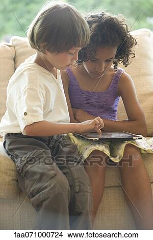 Boy and girl using digital tablet View Large Photo Image Picture - Boy and girl using digital tablet. Fotosearch