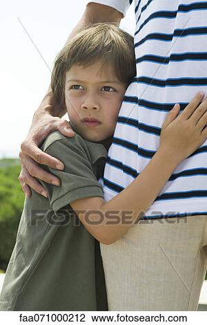 Boy embracing father, cropped View Large Photo Image Stock Image - Boy embracing father, cropped. Fotosearch
