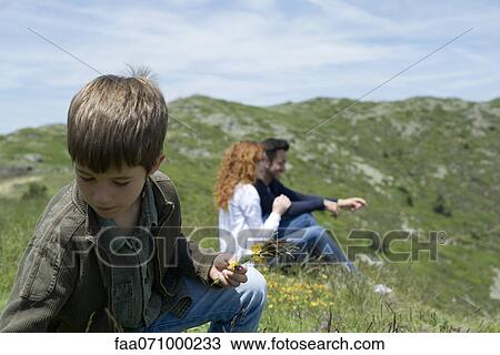 Boy picking yellow flowers View Large Photo Image Stock Image - Boy picking yellow flowers. Fotosearch