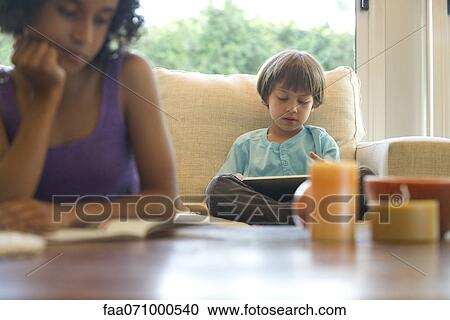 Stock Image - Boy reading e-book. Fotosearch