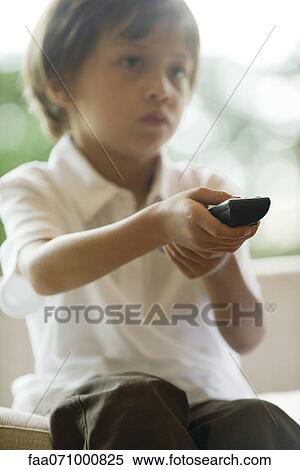 Boy watching TV, remote control in hands View Large Photo Image Stock Photography - Boy watching TV, remote control in hands. Fotosearch