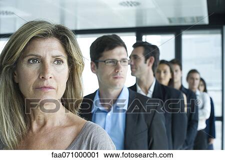 Stock Image - Business associates standing in a row. Fotosearch