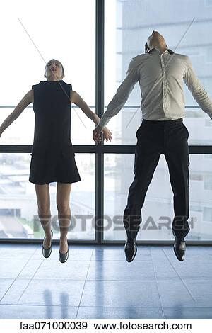 Businessman and businesswoman jumping View Large Photo Image Stock Photo - Businessman and businesswoman jumping. Fotosearch