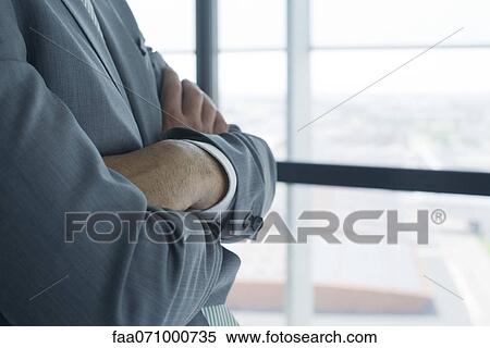Stock Photography - Businessman with arms folded, mid section. Fotosearch