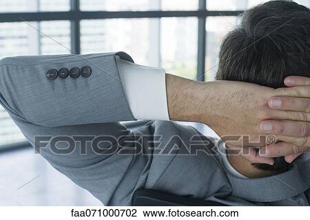 Businessman with hands behind head, rear view View Large Photo Image Stock Image - Businessman with hands behind head, rear view. Fotosearch