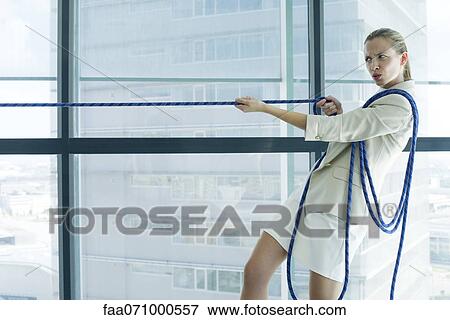 Businesswoman playing tug of war View Large Photo Image Stock Photo - Businesswoman playing tug of war. Fotosearch