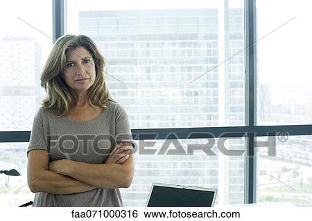 Stock Photograph - Businesswoman with arms folded. Fotosearch
