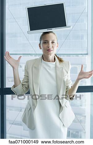 Businesswoman with laptop computer on head View Large Photo Image Stock Photo - Businesswoman with laptop computer on head. Fotosearch