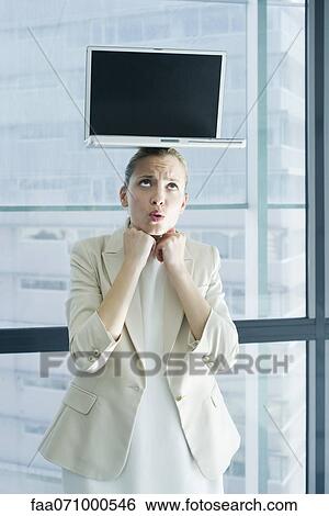 Businesswoman with laptop computer on head View Large Photo Image Stock Photograph - Businesswoman with laptop computer on head. Fotosearch