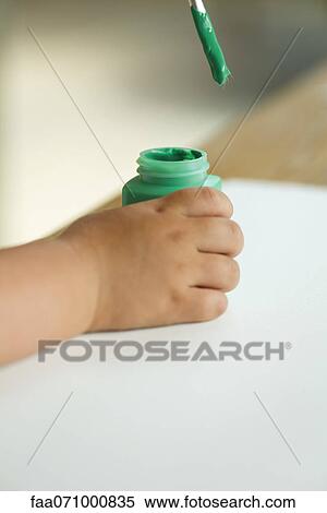 Child dipping paintbrush into paint, cropped View Large Photo Image Stock Photography - Child dipping paintbrush into paint, cropped. Fotosearch