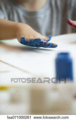 Stock Image - Child finger painting, cropped. Fotosearch
