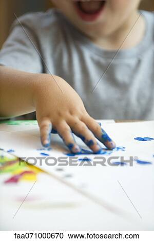Stock Image - Child finger painting, cropped. Fotosearch
