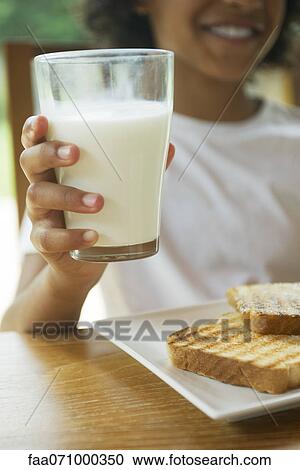 Child holding glass of milk, cropped View Large Photo Image Stock Image - Child holding glass of milk, cropped. Fotosearch