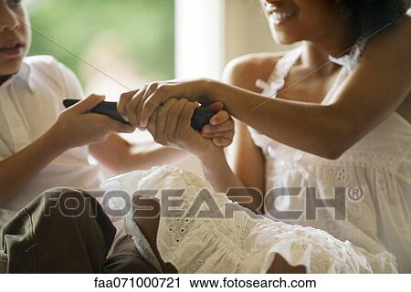 Children fighting over remote control, cropped View Large Photo Image Stock Image - Children fighting over remote control, cropped. Fotosearch