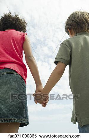 Children holding hands, rear view View Large Photo Image Stock Photography - Children holding hands, rear view. Fotosearch