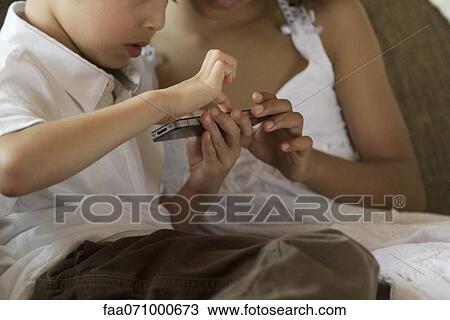 Children playing with smartphone View Large Photo Image Stock Image - Children playing with smartphone. Fotosearch