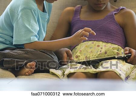 Children using digital tablet, cropped View Large Photo Image Stock Image - Children using digital tablet, cropped. Fotosearch