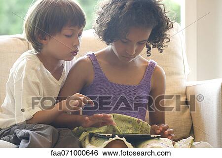Children using digital tablet View Large Photo Image Stock Photograph - Children using digital tablet. Fotosearch