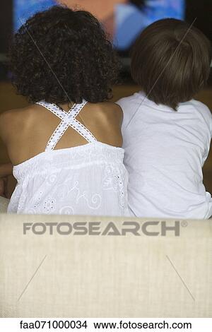 Children watching TV, rear view View Large Photo Image Picture - Children watching TV, rear view. Fotosearch