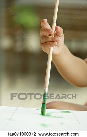 Child's hand holding paintbrush View Large Photo Image Stock Image - Child's hand holding paintbrush. Fotosearch