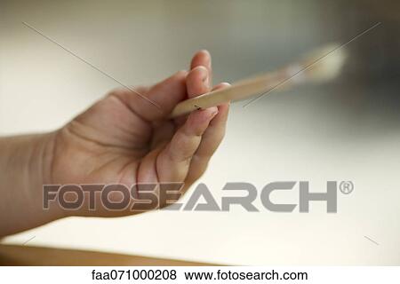 Stock Photo - Child's hand holding paintbrush. Fotosearch