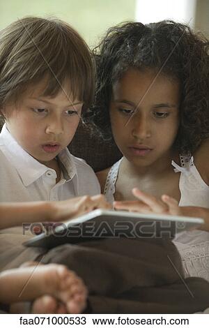 Chldren using digital tablet View Large Photo Image Stock Image - Chldren using digital tablet. Fotosearch