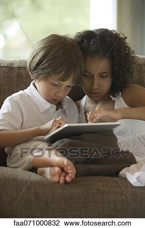Chldren using digital tablet View Large Photo Image Stock Image - Chldren using digital tablet. Fotosearch