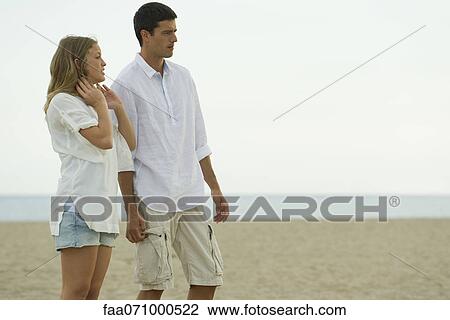 Couple relaxing at the beach View Large Photo Image Stock Image - Couple relaxing at the beach. Fotosearch