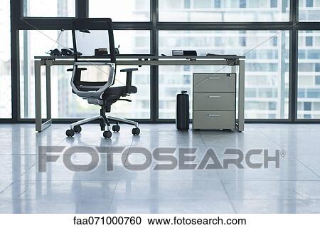 Desk and office chair in empty office View Large Photo Image Stock Image - Desk and office chair in empty office. Fotosearch