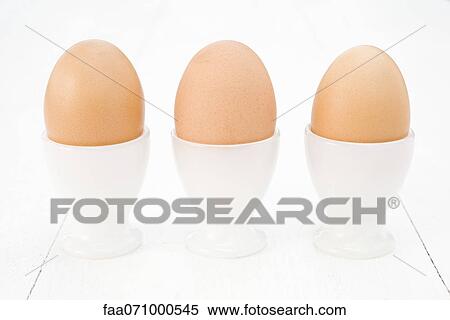 Eggs in egg cups View Large Photo Image Stock Photography - Eggs in egg cups. Fotosearch