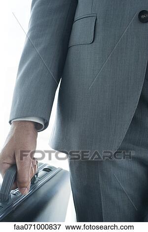 Executive carrying briefcase, mid section View Large Photo Image Stock Photo - Executive carrying briefcase, mid section. Fotosearch