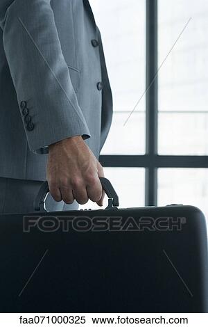 Executive carrying briefcase View Large Photo Image Stock Photography - Executive carrying briefcase. Fotosearch