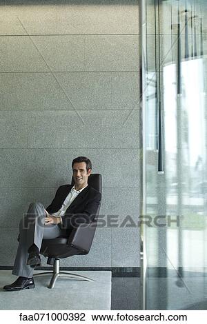 Executive sitting in lobby View Large Photo Image Stock Image - Executive sitting in lobby. Fotosearch