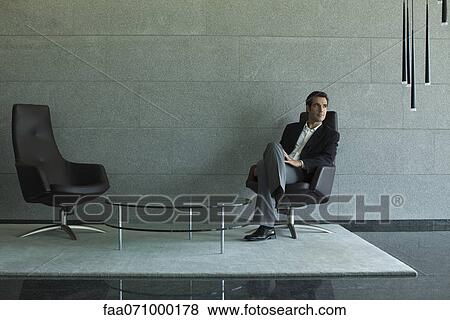 Executive sitting in lobby View Large Photo Image Stock Photo - Executive sitting in lobby. Fotosearch