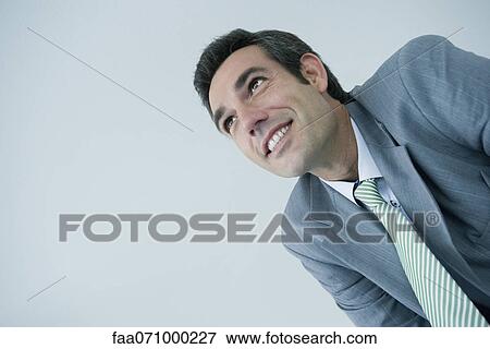 Executive smiling, low angle view View Large Photo Image Stock Photo - Executive smiling, low angle view. Fotosearch