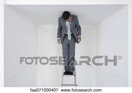 Executive standing on stepladder View Large Photo Image Stock Photo - Executive standing on stepladder. Fotosearch