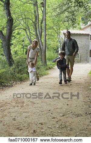 Family hiking in woods View Large Photo Image Stock Photo - Family hiking in woods. Fotosearch