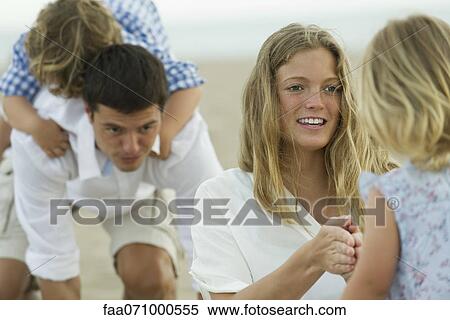Family playing at the beach View Large Photo Image Stock Photography - Family playing at the beach. Fotosearch