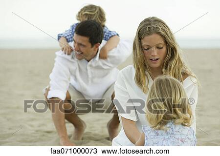Family playing together at the beach View Large Photo Image Stock Image - Family playing together at the beach. Fotosearch