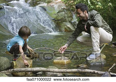 Father and son exploring nature View Large Photo Image Stock Image - Father and son exploring nature. Fotosearch