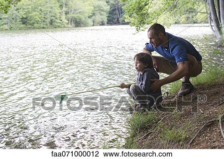 Father and son fishing View Large Photo Image Stock Image - Father and son fishing. Fotosearch