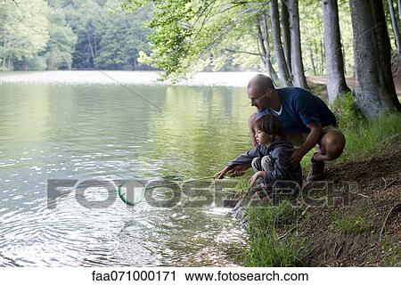 Father and son fishing View Large Photo Image Stock Image - Father and son fishing. Fotosearch