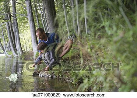 Father and son fishing View Large Photo Image Stock Photo - Father and son fishing. Fotosearch