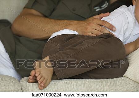 Father and son napping together on sofa View Large Photo Image Picture - Father and son napping together on sofa. Fotosearch