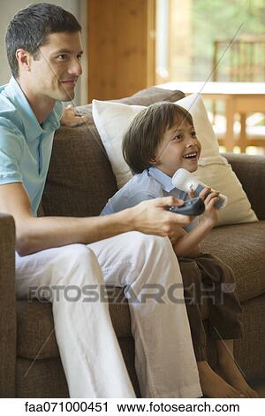 Father and son playing video game together View Large Photo Image Stock Image - Father and son playing video game together. Fotosearch