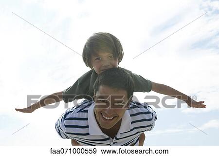 Father carrying son on back, portrait View Large Photo Image Stock Photo - Father carrying son on back, portrait. Fotosearch