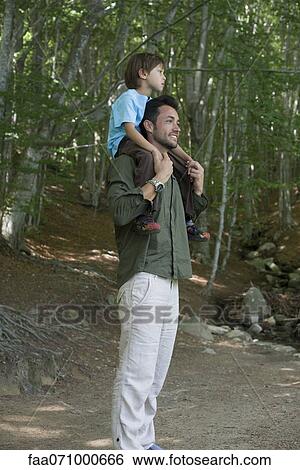 Stock Photograph - Father carrying son on shoulders. Fotosearch