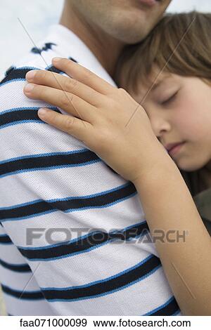 Father holding young son, cropped View Large Photo Image Stock Photo - Father holding young son, cropped. Fotosearch