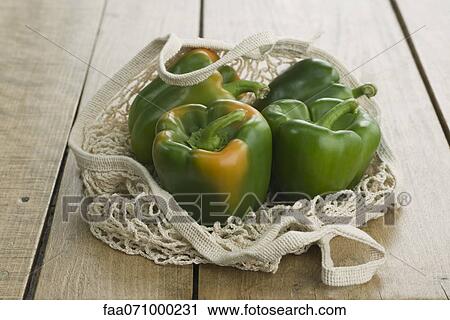Fresh green bell peppers in mesh shopping bag View Large Photo Image Stock Image - Fresh green bell peppers in mesh shopping bag. Fotosearch