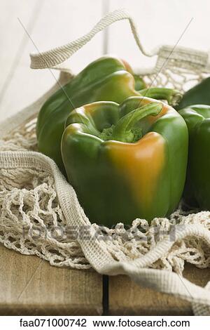 Fresh green bell peppers in mesh shopping bag View Large Photo Image Stock Image - Fresh green bell peppers in mesh shopping bag. Fotosearch